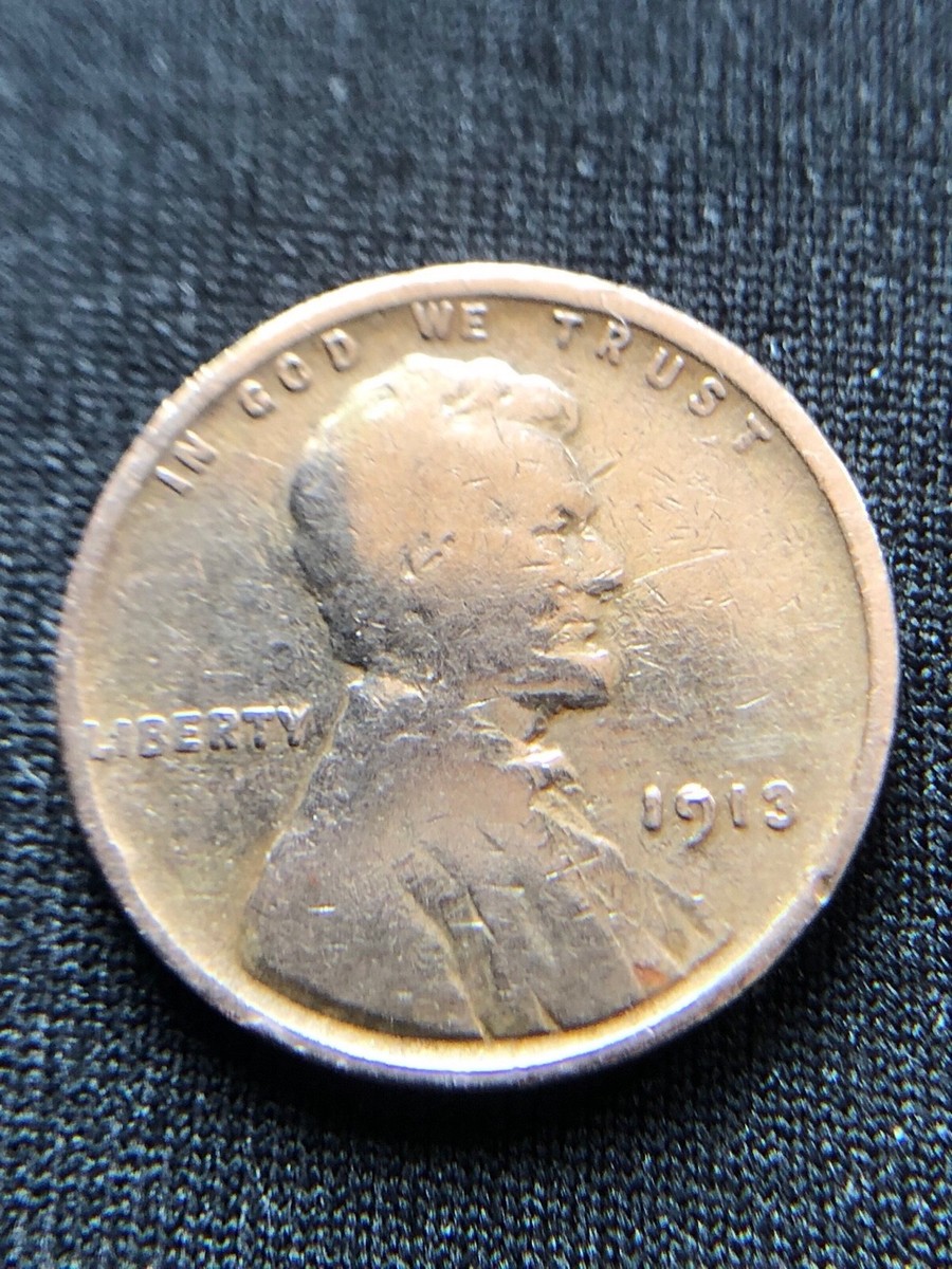 1913 Lincoln wheat penny die cud error showing raised blank area at the coin rim